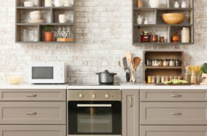 A closeup of an interior kitchen with white brick and light gray countertops