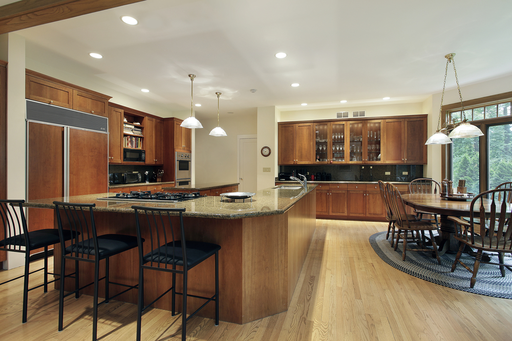 An expanded view of a kitchen's space with a U-shaped kitchen island